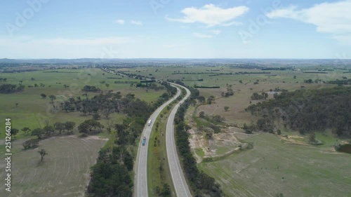 Static aerial view of cars and trucks driving on Hume Highway in Australian countryside photo