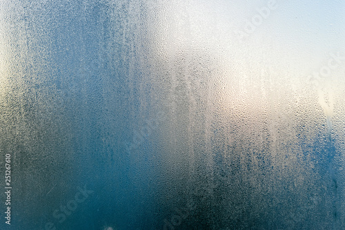 Close up on condensated water foggy window glass natural textured background.