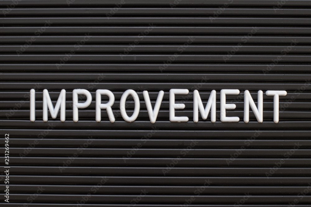 Black color felt letter board with white alphabet in word improvement background