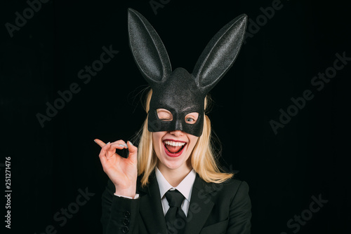Portrait of a happy woman in bunny ears winking. Young girl easter woman in bunny ears. Sweet lovely attractive adorable charming cheerful positive girl in bunny ears celebrating Easter