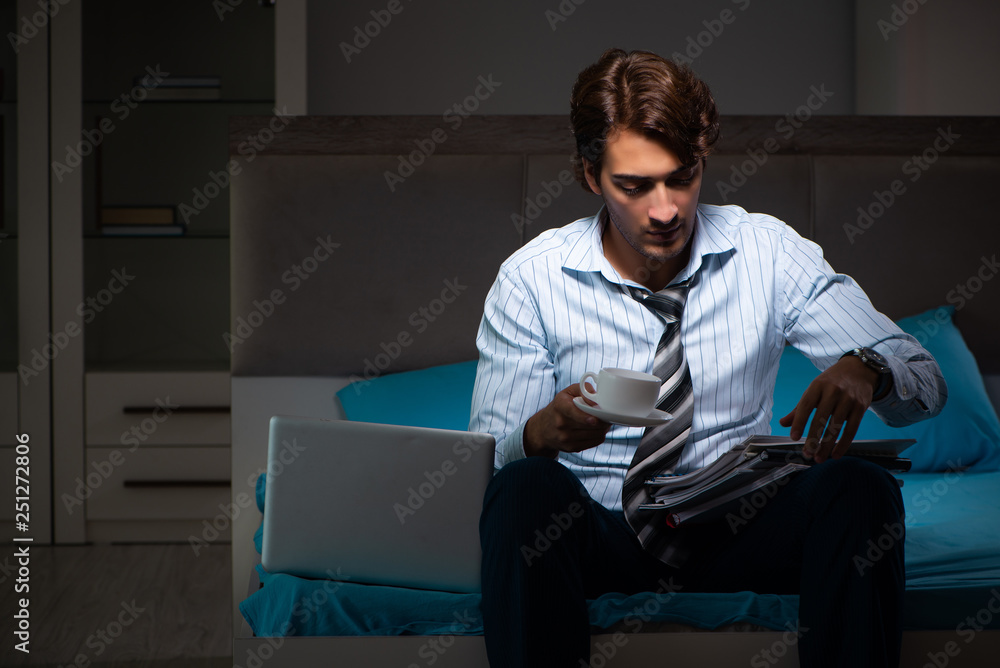 Tired businessman working overtime at home at night Tired businessman working overtime at home at night
