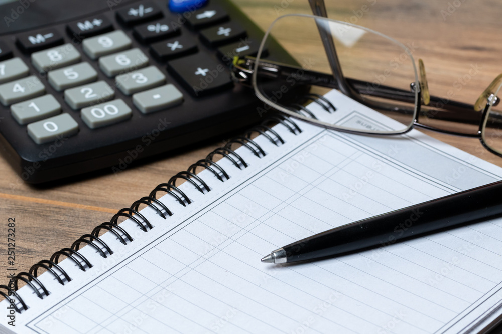 side view calculator notebook and glasses side view calculator notebook and glasses
