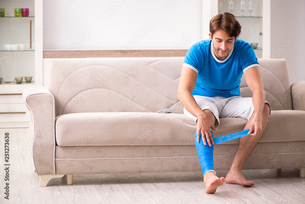 Leg injured young man on the sofa Leg injured young man on the sofa