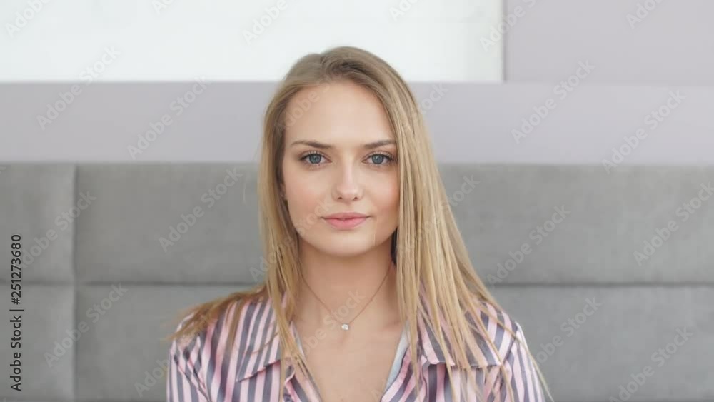 Attractive girl with beautiful blue eyes looking at camera while resting in bedroom. Lifestyle, Beauty concept Attractive girl with beautiful blue eyes looking at camera while resting in bedroom. Lifestyle, Beauty concept