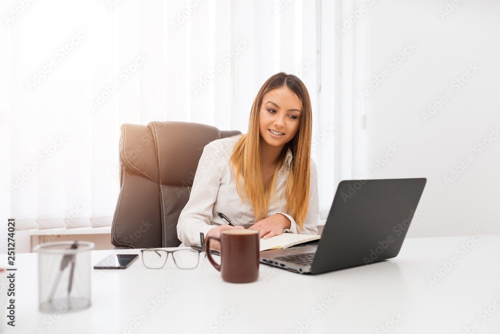 A pretty young student works on finishing work at the faculty. A pretty young student works on finishing work at the faculty.