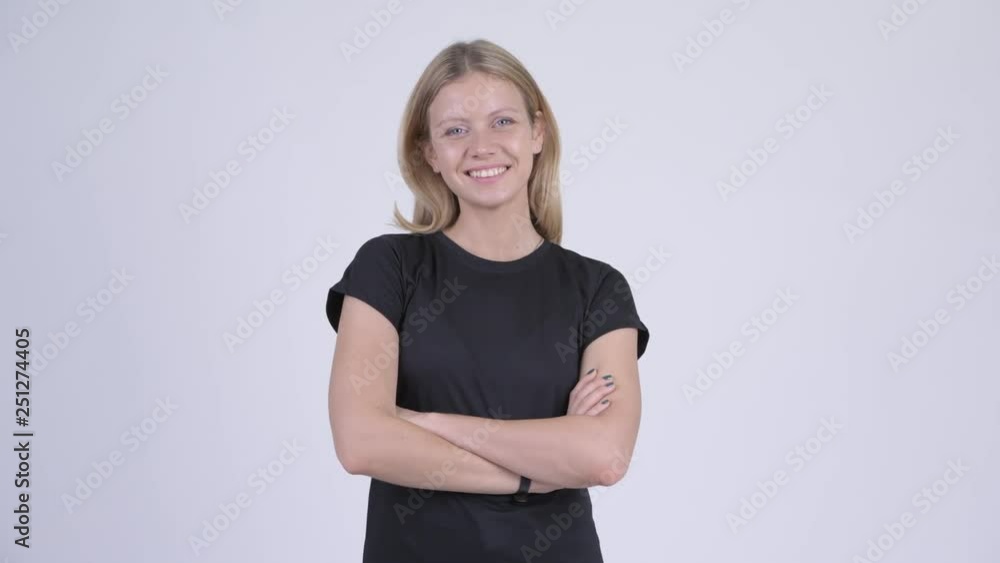 Young happy blonde woman smiling with arms crossed Young happy blonde woman smiling with arms crossed