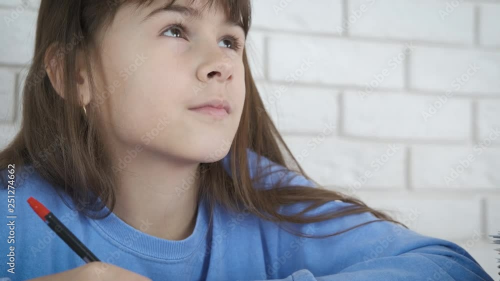 Dreaming child learning. A cute little girl thinks and writes in a notebook. Dreaming child learning. A cute little girl thinks and writes in a notebook.