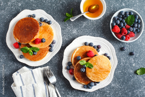 Pancakes with berries and honey.