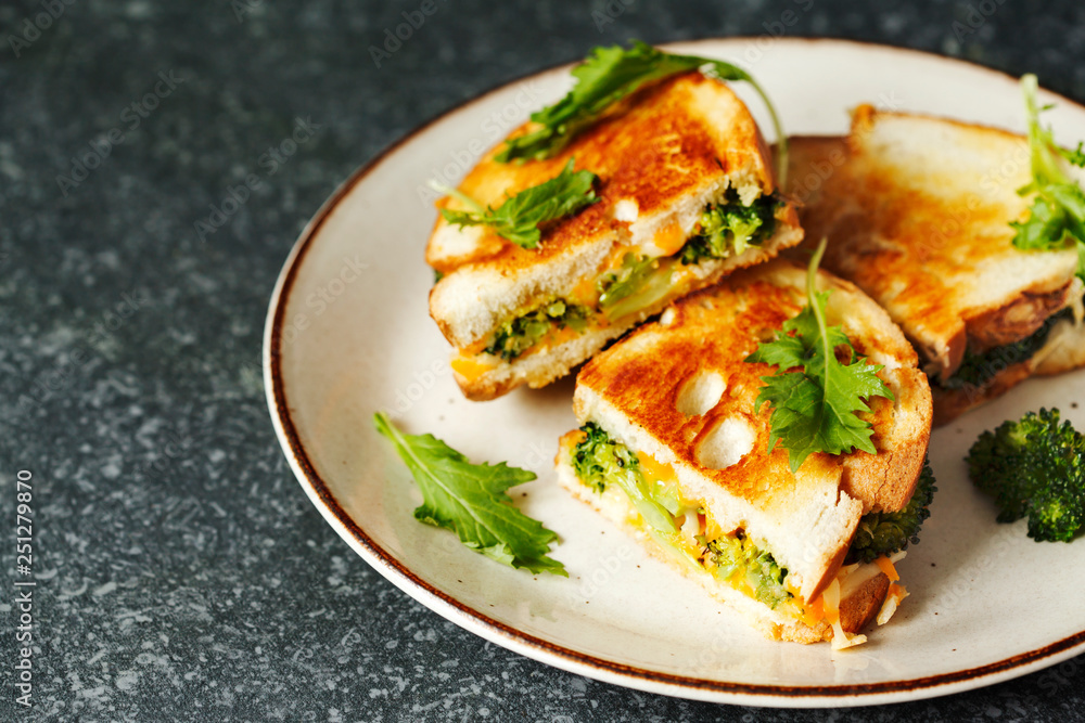 Broccoli and cheddar cheese sandwiches on plate Broccoli and cheddar cheese sandwiches on plate