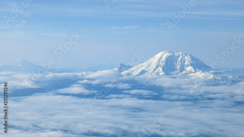 the aerial view of mount rainier, mount adams and mt st helens near seattle