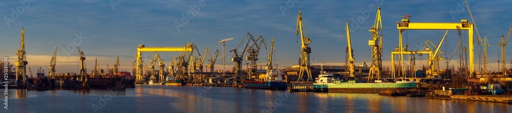 industrial areas of the shipyard in Szczecin in Poland,merchant ship in the dry dock of the repair yard,panorama with high resolution and detail