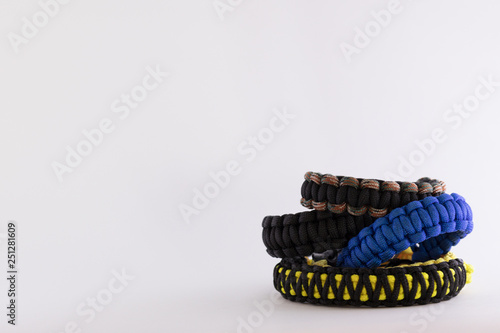 pile of paracord bracelets on a blank white background
