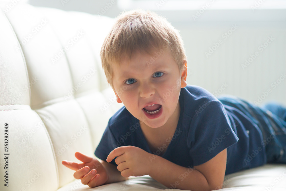 Portrait of hysterical boy. Upset caucasian kid crying at home. Portrait of hysterical boy. Upset caucasian kid crying at home.