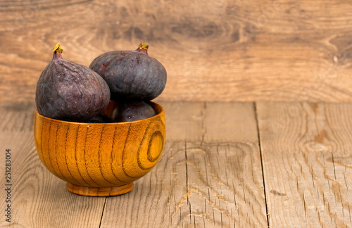 whole fresh fig fruits in wooden plate photo