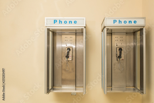 Two old payphones on the wall