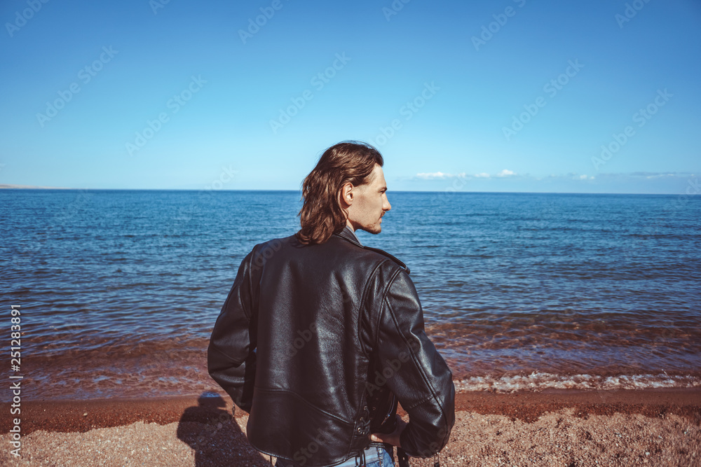 the guy stands on the beach