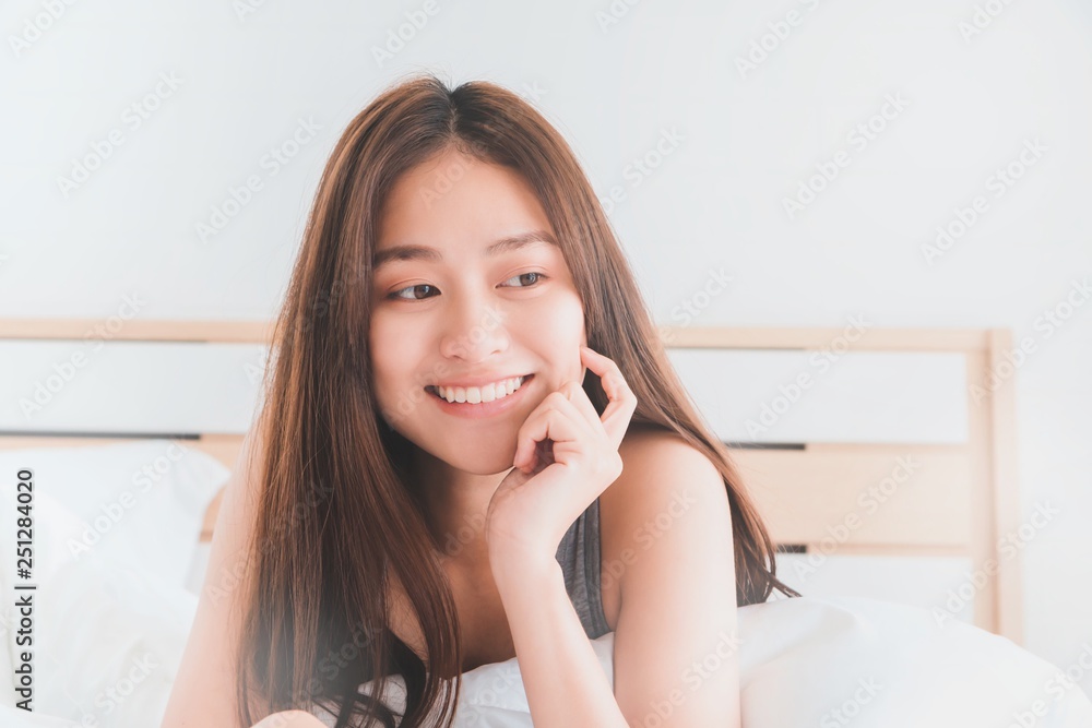 Young Asian beautiful woman smiling and relax on bed in bedroom.Health and beauty woman concept. Young Asian beautiful woman smiling and relax on bed in bedroom.Health and beauty woman concept.