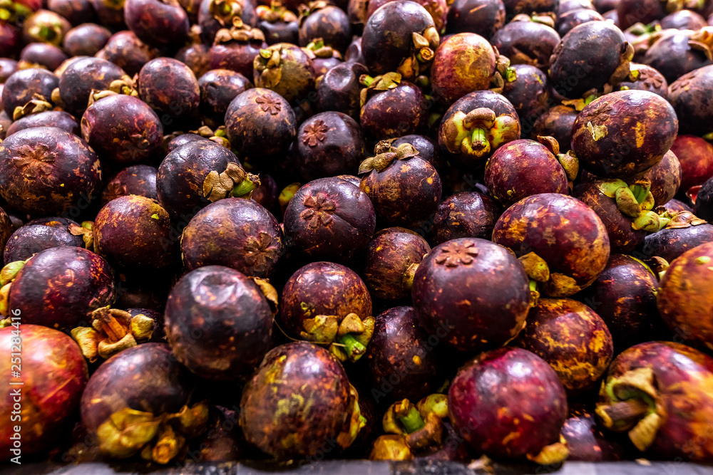 Fototapeta premium Fresh organic exotic fruit mangosteen on a local food market, Bali island. Mangosteen background.