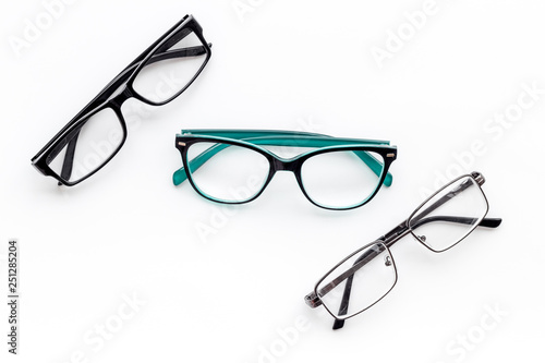 Set of glasses with transparent lenses on white background top view space for text