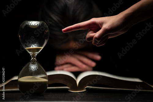 Finger of Person Pointing to Time while Woman Sleeps Over Bible