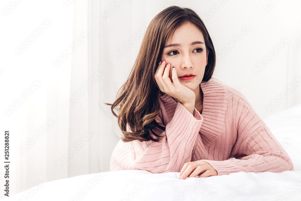 Portrait of happy smile asia woman enjoy and relax on the bed in bedroom at home.asian beauty Portrait of happy smile asia woman enjoy and relax on the bed in bedroom at home.asian beauty