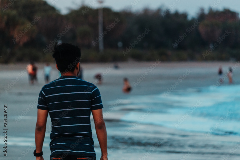 Man walking on the beach Man walking on the beach
