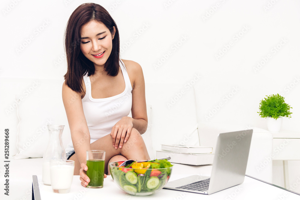 Woman enjoy healthy drinking green detox vegetable juice in the living room at home.dieting concept.healthy lifestyle
