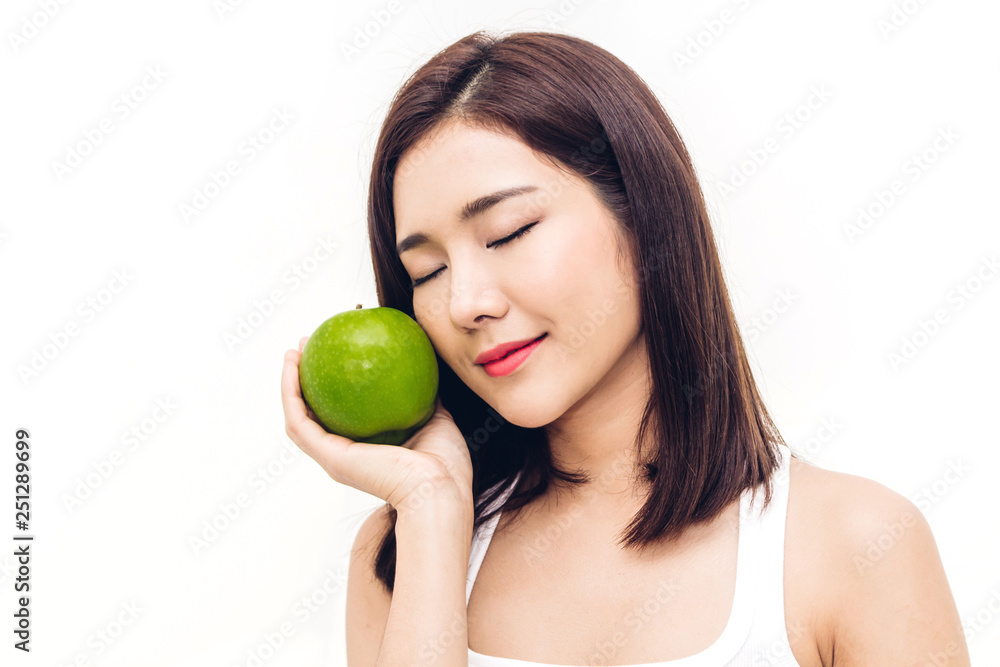 Woman holding and eating fresh green apple on white background.dieting concept.healthy lifestyle Woman holding and eating fresh green apple on white background.dieting concept.healthy lifestyle