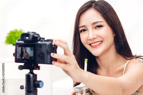 Asia woman blogger in front of camera recording herself.social media concept © Art_Photo