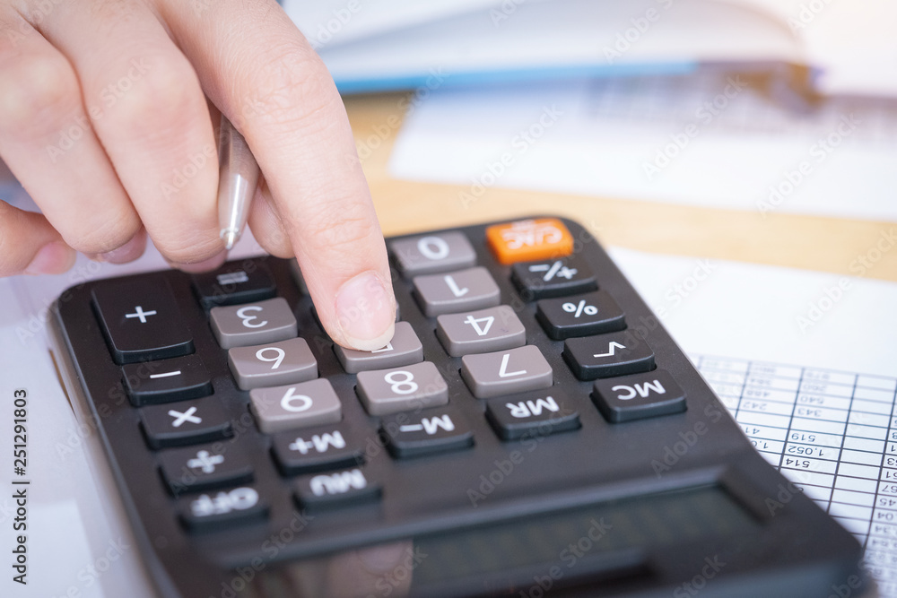Businesswoman working in the office with calculator for financial data analyzing counting. Business financial analysis and strategy concept. Businesswoman working in the office with calculator for financial data analyzing counting. Business financial analysis and strategy concept.
