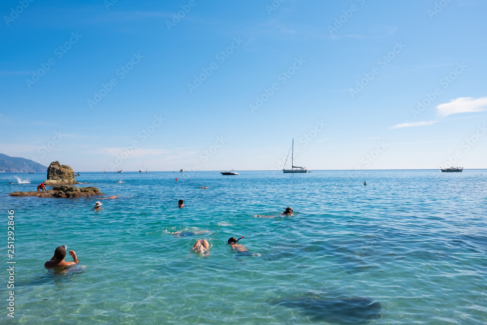 People are having fun on the beach of Monterosso al Mare in Liguria, Italy