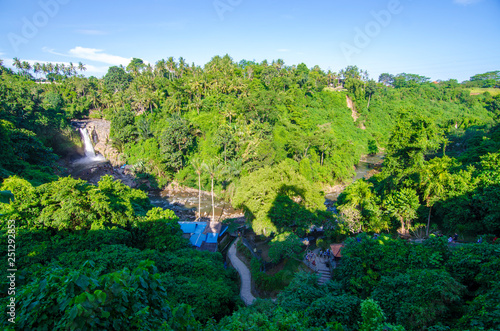 Tegenungan waterfall from hill with blue skies above Kemenuh Village, Sukawati, Gianyar, Bali, Indonesia photo