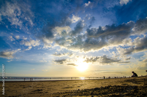 A couple enjoy their sunset at Double Six Beach, Legian, Seminyak, Kuta, Bali, Indonesia