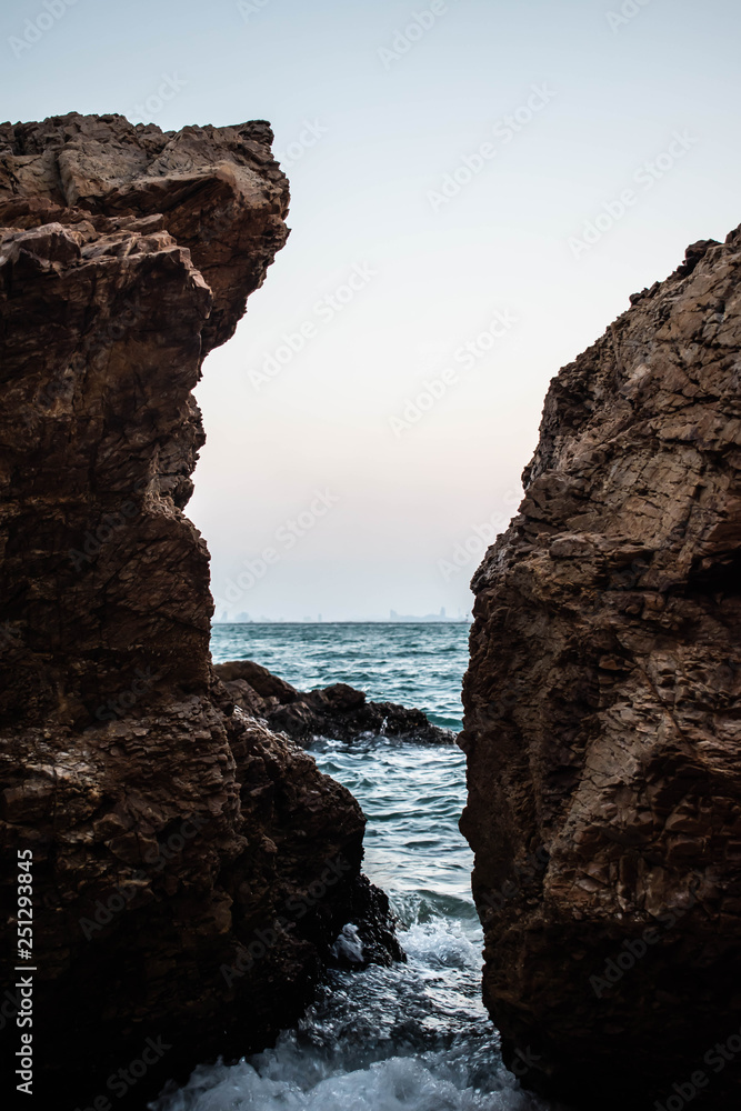  The sea between the rocks in the sunset