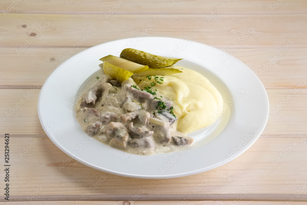 Goulash with mashed potato and pickled cucumber Goulash with mashed potato and pickled cucumber