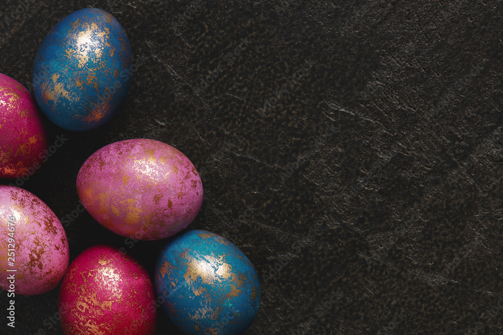 Background with painted colorful Easter eggs with golden spots Background with painted colorful Easter eggs with golden spots