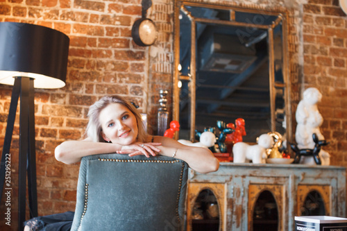 fashion details of elegant beautiful woman sitting barefoot in vintage cafe in black velvet dress, rich stylish lady, elegant trend, took off her shoes, golden high heeles sandals, footwear photo