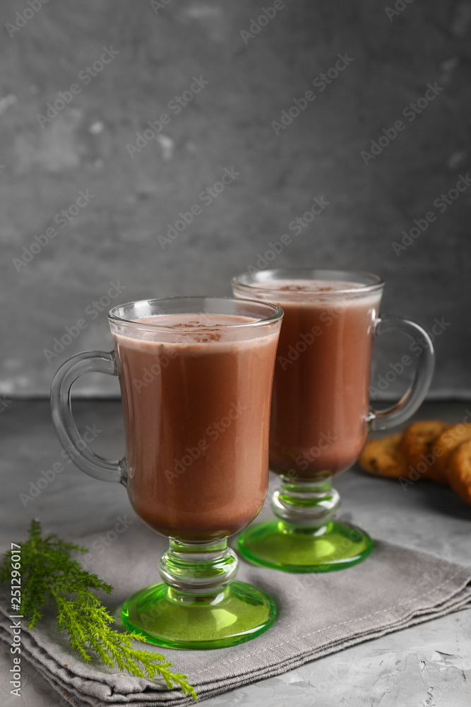 Glass cups of hot cacao drink on grey table Glass cups of hot cacao drink on grey table