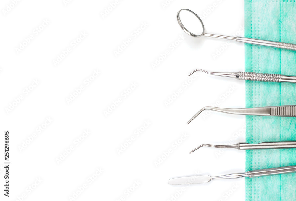 Dentist's tools and mask on white background. Dentist's tools and mask on white background.