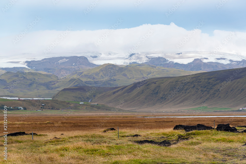 beautiful landscape view in Iceland during road trip. Blue sky, mountain and green field