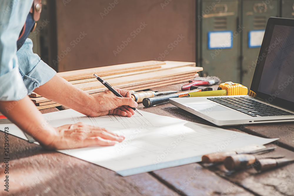 Carpenter working with equipment on wooden table in carpentry shop. woman works in a carpentry shop. - obrazy, fototapety, plakaty 