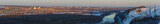 Evening lighting over the city. Sunset time in the twilight sky. Panoramic top view of residential district.