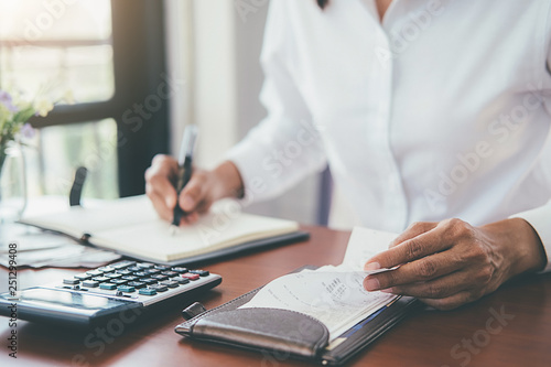 Tableau sur toile Woman with bills and calculator