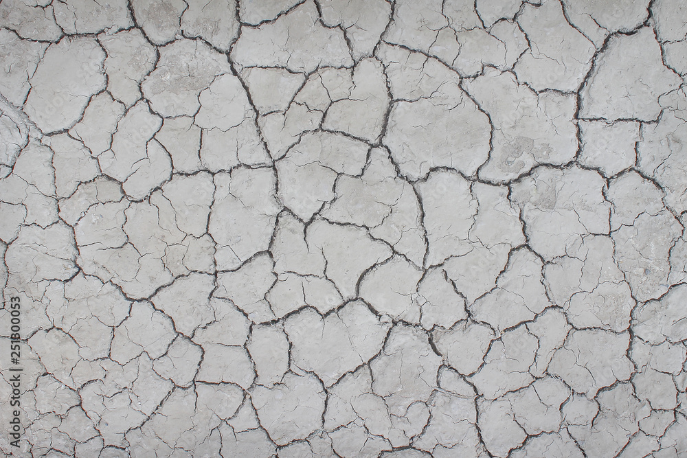 Top view cracked patterns of soil ground texture for grey white background , nature drought Top view cracked patterns of soil ground texture for grey white background , nature drought