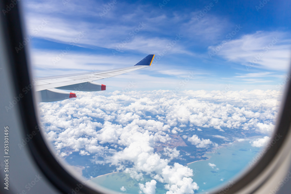 Airplane wing view out of the window the cloudy sky background, Travel and Holiday vacation concept Airplane wing view out of the window the cloudy sky background, Travel and Holiday vacation concept