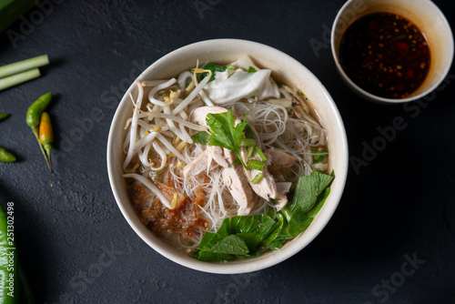 Rice noodles soup and chicken photo