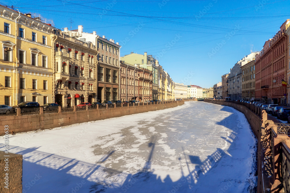 Canal in center of St. Petersburg in winter among ancient houses