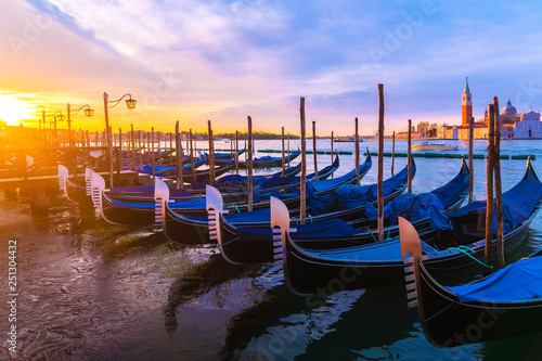Gondolas moored by Saint Mark square with San Giorgio di Maggiore church in Venice, Italy © dimbar76