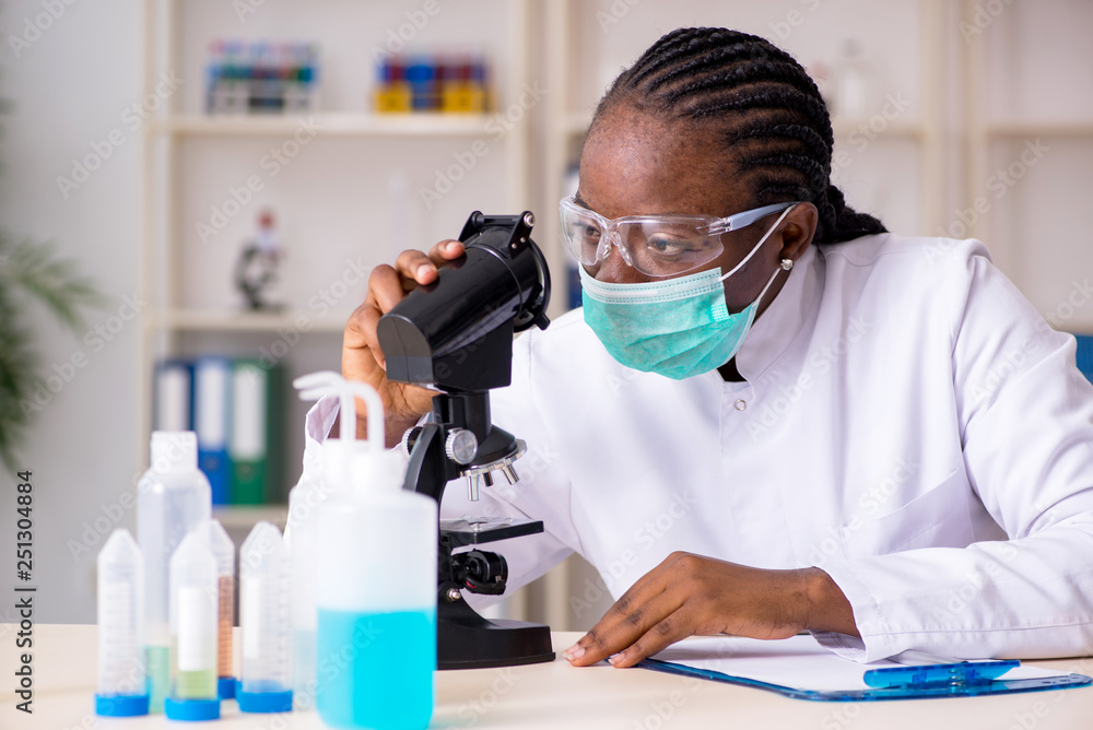 Young black chemist working in the lab Young black chemist working in the lab