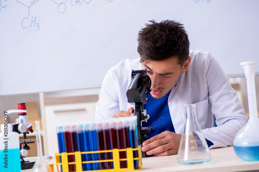 Young chemist sitting in the lab Young chemist sitting in the lab